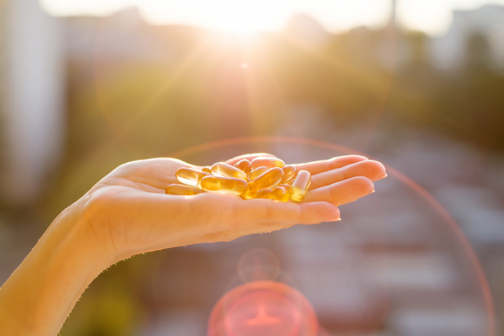 hand-woman-holding-fish-oil-omega-3-capsules.jpg